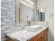 Bathroom vanity with marble countertop and decorative mirror at 7036 E Sheena Dr, Scottsdale, AZ 85254