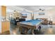 Spacious game room with a pool table, fireplace, and comfortable seating at 7036 E Sheena Dr, Scottsdale, AZ 85254