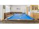 Bright game room with a pool table and a cozy corner couch at 7036 E Sheena Dr, Scottsdale, AZ 85254