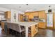 Spacious kitchen with a large island, wooden cabinets, and stainless steel appliances at 7036 E Sheena Dr, Scottsdale, AZ 85254