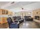 Open-concept living area includes a kitchen, fireplace, and leather reclining furniture at 7036 E Sheena Dr, Scottsdale, AZ 85254
