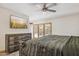Main bedroom with a ceiling fan, wood floors, television and a comfortable king-sized bed at 7036 E Sheena Dr, Scottsdale, AZ 85254