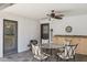 Covered patio with tiled floor, ceiling fan, and dining set at 7036 E Sheena Dr, Scottsdale, AZ 85254