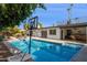 Home's outdoor pool area includes a basketball hoop, lounge chairs and patio seating at 7036 E Sheena Dr, Scottsdale, AZ 85254