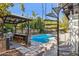 Outdoor pool area features a bar, seating and spiral staircase to rooftop deck at 7036 E Sheena Dr, Scottsdale, AZ 85254