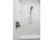 Shower featuring marble-look tile, pebble-look accents and a modern shower head at 7036 E Sheena Dr, Scottsdale, AZ 85254