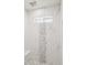 Modern shower with marble wall tile and window at 7036 E Sheena Dr, Scottsdale, AZ 85254