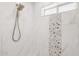 Walk-in shower with marble-look tile and a modern shower head at 7036 E Sheena Dr, Scottsdale, AZ 85254