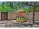 Tranquil backyard setting with decorative rock, garden bed, mature tree and ample shade for outdoor enjoyment at 7202 N 16Th Dr, Phoenix, AZ 85021
