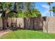 Expansive backyard showcases a large gate, lush green grass, and mature trees for optimal outdoor activities at 7202 N 16Th Dr, Phoenix, AZ 85021