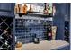 Stylish bar area featuring sleek blue cabinetry, elegant glassware, and a countertop for serving drinks at 7202 N 16Th Dr, Phoenix, AZ 85021