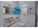 This stylish bathroom has gray walls, white tile and white fixtures with lots of natural light at 7202 N 16Th Dr, Phoenix, AZ 85021