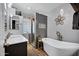 Modern bathroom featuring tiled shower, soaking tub and flower-shaped light fixture at 7202 N 16Th Dr, Phoenix, AZ 85021