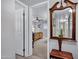 Hallway view into the home's bright bedroom featuring a ceiling fan and plantation shutters at 7202 N 16Th Dr, Phoenix, AZ 85021