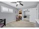 This well lit bedroom has a built-in desk, a rocking chair, and large sliding door closet at 7202 N 16Th Dr, Phoenix, AZ 85021