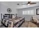 Bedroom with gray walls, black bedframe, and ceiling fan for a comfortable, modern feel at 7202 N 16Th Dr, Phoenix, AZ 85021