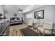 Spacious bedroom featuring hard wood floors, ceiling fan and two comfortable arm chairs at 7202 N 16Th Dr, Phoenix, AZ 85021