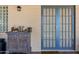 Charming home entrance with a decorative cabinet adding warmth to the blue-framed double doors at 7202 N 16Th Dr, Phoenix, AZ 85021