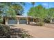 Charming home with a well-maintained front yard, featuring mature trees and a two-car garage at 7202 N 16Th Dr, Phoenix, AZ 85021