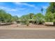 Well-maintained home featuring mature trees, desert landscaping, a long driveway, and a two-car garage at 7202 N 16Th Dr, Phoenix, AZ 85021