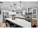 Bright kitchen boasts a large island with seating, stainless appliances, and sleek cabinets, creating a modern and functional space at 7202 N 16Th Dr, Phoenix, AZ 85021