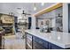Open concept kitchen with large island and an adjacent dining area with stone fireplace in the background at 7202 N 16Th Dr, Phoenix, AZ 85021
