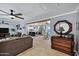 Open-concept living space with a view into the kitchen featuring tile floors, neutral colors, and ceiling fans at 7202 N 16Th Dr, Phoenix, AZ 85021