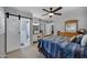 Comfortable main bedroom boasts a barn door that opens to the en-suite bathroom and vanity at 7202 N 16Th Dr, Phoenix, AZ 85021