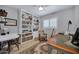 This beautiful home office boasts a large built-in bookcase, a writing desk and lots of light at 7202 N 16Th Dr, Phoenix, AZ 85021