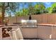 Outdoor stainless steel BBQ with brick accents and wood storage provides great entertainment in a backyard oasis at 7202 N 16Th Dr, Phoenix, AZ 85021