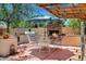 Outdoor kitchen with brick fireplace, built in BBQ, and dining area, great for entertainment in a backyard oasis at 7202 N 16Th Dr, Phoenix, AZ 85021