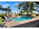 Inviting pool with waterfall and umbrella offers a serene backyard retreat for cooling off on hot days at 7202 N 16Th Dr, Phoenix, AZ 85021