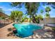 Beautiful pool with waterfall feature, palm trees, and ample space for entertaining in a backyard oasis at 7202 N 16Th Dr, Phoenix, AZ 85021
