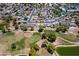 Serene aerial view featuring a residential area and a lush green golf course with tranquil ponds at 7318 S Mcallister Ave, Tempe, AZ 85283