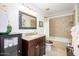 Traditional bathroom with a granite vanity, framed mirror, and tiled shower-tub combo at 7318 S Mcallister Ave, Tempe, AZ 85283