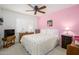 Cozy bedroom with a ceiling fan, shuttered window, and a comfortable-looking bed at 7318 S Mcallister Ave, Tempe, AZ 85283