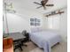 Comfortable bedroom featuring a desk, ceiling fan, and natural light from a window at 7318 S Mcallister Ave, Tempe, AZ 85283