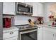 Close up of a modern kitchen appliance including stainless steel oven, microwave, and glass cooktop at 7318 S Mcallister Ave, Tempe, AZ 85283