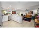 Bright kitchen features stainless steel appliances, tile floors and an island, open to the living room and fireplace at 7318 S Mcallister Ave, Tempe, AZ 85283
