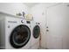 Laundry room featuring a stacked washer and dryer with shelving and a white utility door at 7318 S Mcallister Ave, Tempe, AZ 85283