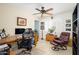 Well-lit home office with a ceiling fan, a large wooden desk and comfortable seating at 7318 S Mcallister Ave, Tempe, AZ 85283
