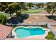 Aerial view of private backyard pool with lush landscaping overlooking the golf course at 7318 S Mcallister Ave, Tempe, AZ 85283
