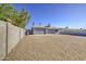 Spacious backyard features privacy wall, gravel groundcover, and access door at 7332 W Desert Cove Ave, Peoria, AZ 85345