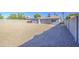 Large, gravel-covered backyard with block fence and access door to the home at 7332 W Desert Cove Ave, Peoria, AZ 85345