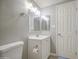 This bathroom has a single sink vanity with a framed mirror and great lighting at 7332 W Desert Cove Ave, Peoria, AZ 85345
