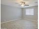 Bedroom featuring light-colored tile flooring, a ceiling fan, and natural light from the window at 7332 W Desert Cove Ave, Peoria, AZ 85345