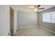 Bedroom featuring light wood-look floors, grey walls, a ceiling fan, and a window at 7332 W Desert Cove Ave, Peoria, AZ 85345