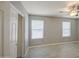 Bedroom featuring light wood-look floors, grey walls, a ceiling fan, and two windows at 7332 W Desert Cove Ave, Peoria, AZ 85345