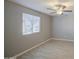 Bedroom featuring light wood-look floors, grey walls, a ceiling fan, and a window at 7332 W Desert Cove Ave, Peoria, AZ 85345