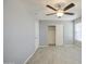 Bedroom featuring light wood-look floors, grey walls, a ceiling fan, closet and window at 7332 W Desert Cove Ave, Peoria, AZ 85345